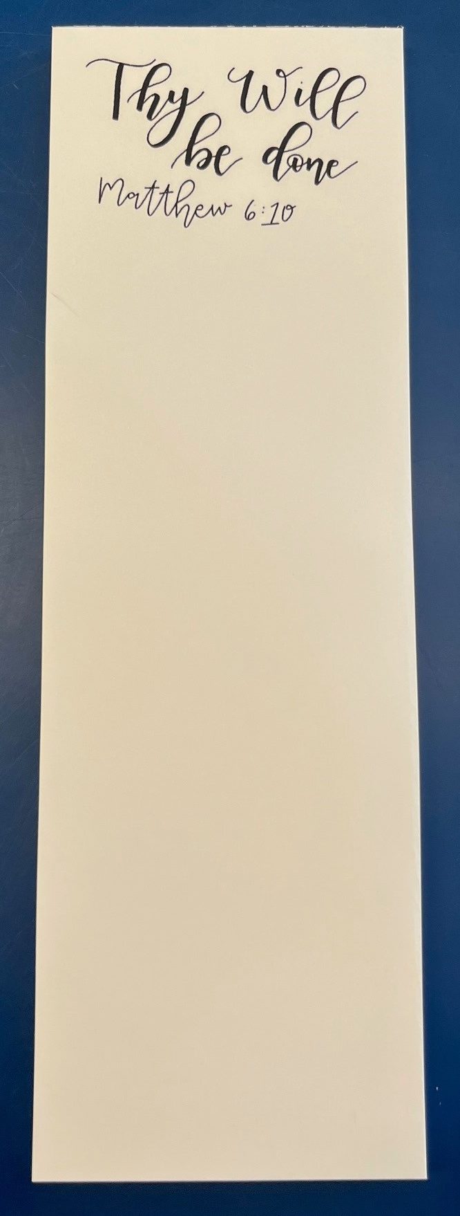 Cream notepad reading Thy Will be done, Matthew 6:10.